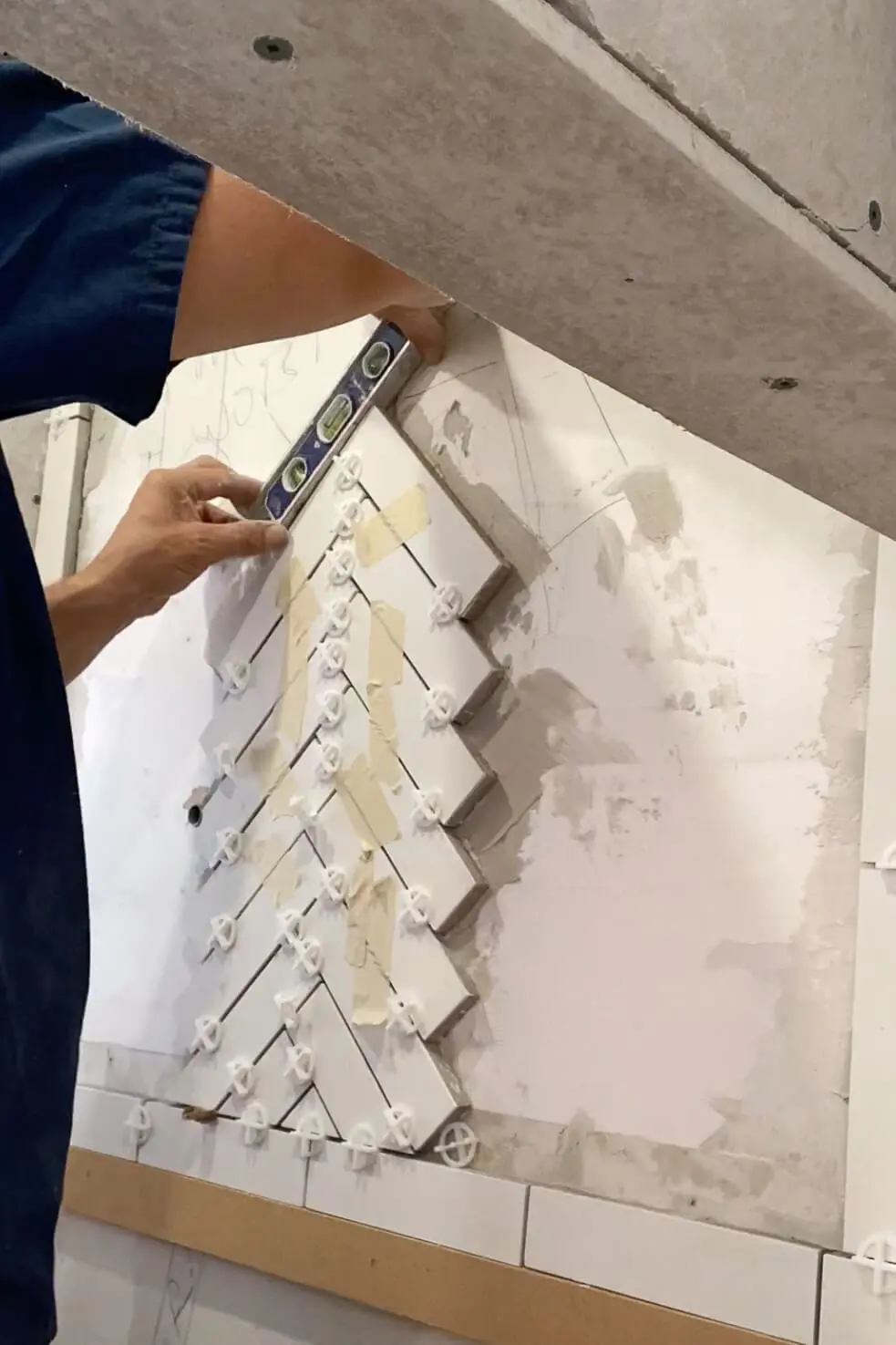 Adding a herringbone pattern tile backsplash.
